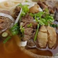 Pho Beef · Slices of round steak and lean brisket with rice stiick noodles, topped with onions and cila...