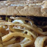 Pueblo Philly · A juicy ribeye Philly cheesesteak with sautéed green peppers, caramelized onions, and Pueblo...