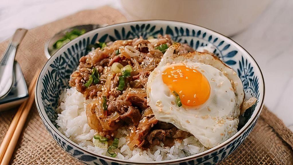 Gyudon (Beef Bowl) · Thinly sliced beef and onions cooked in a sweet soy based sauce and served on rice with one sun egg