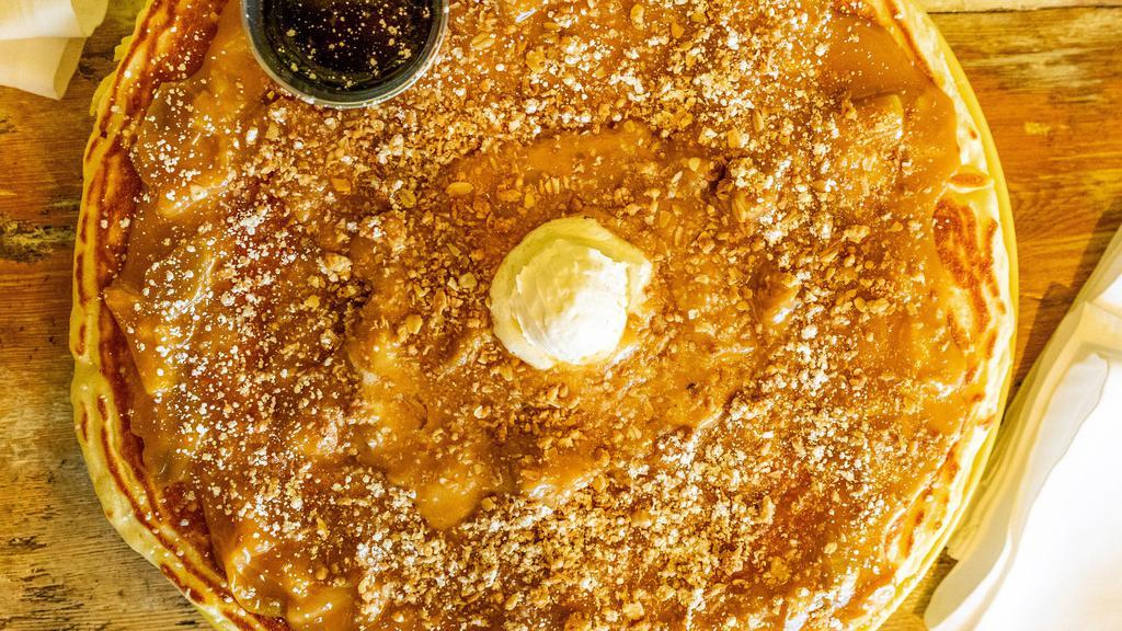 Caramel Apple Hot Cake · Buttermilk pancake, cinnamon butter slow roasted apples, granola, caramel sauce, powdered sugar, and maple syrup.