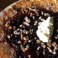 Blueberry Hot Cake · Buttermilk pancake, candied pecans, blueberry sauce, powdered sugar, butter, and maple syrup.