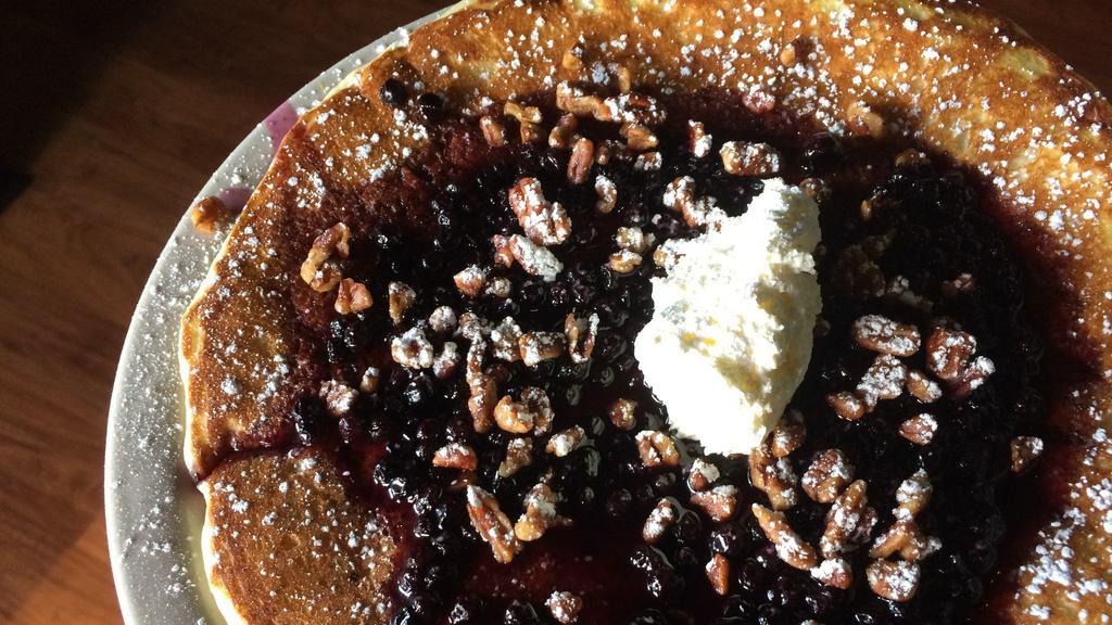 Blueberry Hot Cake · Buttermilk pancake, candied pecans, blueberry sauce, powdered sugar, butter, and maple syrup.