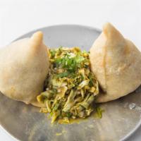 Samosas · Vegetable savory pastry with potatoes, peas (2 per order).