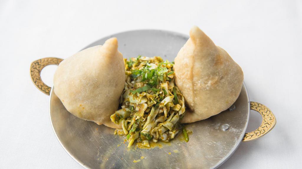 Samosas · Vegetable savory pastry with potatoes, peas (2 per order).