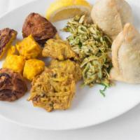 Vegetarian Assortment · A selection of samosas, vegetable pakora, onion bhaji and paneer pakora, served with mint, t...