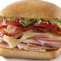 Ultimate Club · Ham, turkey, bacon, Swiss, parmesan, tomatoes, a romaine spinach blend & chipotle mayo on a ...
