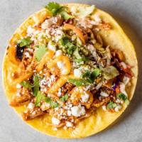 Smoky Pollo Taco · Slow-cooked chicken thighs, onions, queso fresco, cabbage slaw, verde, and plantain sauce, s...