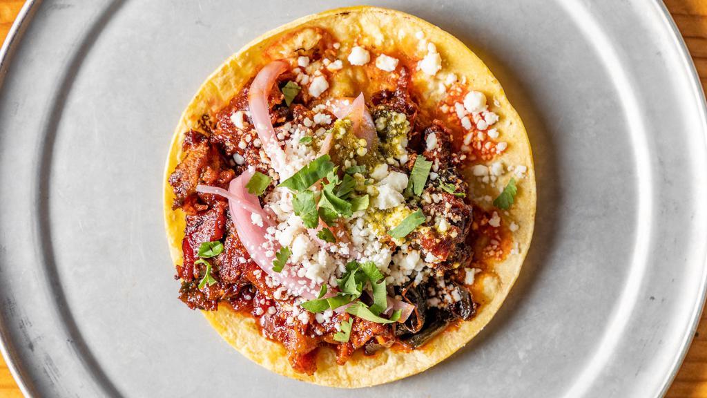 El Diablo Taco · Pork belly and roasted poblano peppers, queso fresco, cabbage slaw, verde, and plantain sauce, served on a corn or flour tortilla.