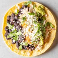 Vegetarian Black Bean Taco · Stewed black beans, queso fresco cabbage slaw, verde, and plantain sauce, served on a corn o...