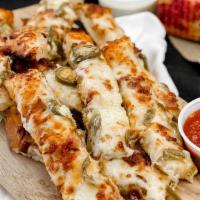 Cheesy Bread · Cheesy bread is served with Cheddar, garlic butter base, mozzarella.