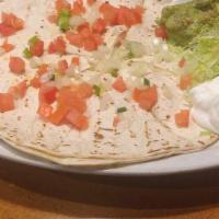 Quesadillas · Crisp flour tortillas stuffed with cheddar and Monterrey cheese, choice of meat or cheese on...