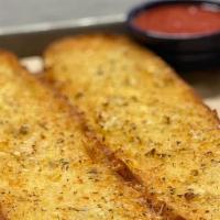 Garlic French Bread · French bread loaf cut in half and toasted with garlic butter. Served with marinara or ranch ...