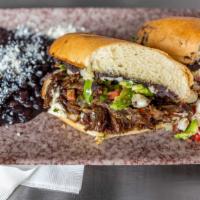 Oxtail Barbacoa Torta · chipotle braised rock river ranch bison oxtail, white hominy salsa,  black bean puree, roast...