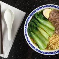 Home-Style Thin Sliced Beef Noodle Soup招牌牛肉拉面 · Served with braised egg, bok choy on top.