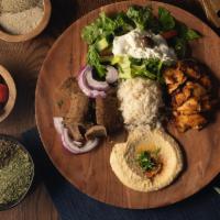 Combination Chicken Shwarma & Gyros Plate · Served with hummus, rice, tzatziki sauce and feta cheese salad.