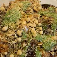 Samosa Chaat · Vegetarian. Chopped samosas smothered with choley & topped with yogurt, mint and tamarind ch...
