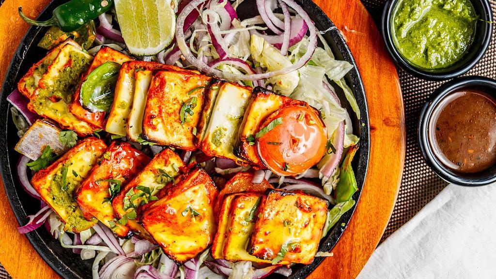 Paneer Parathdar Tikka · Nut free. Indian cottage cheese stuffed with three different layered of homemade relish marinate solid yogurt with indian spices & cooked in charcoal tandoor. nut free.