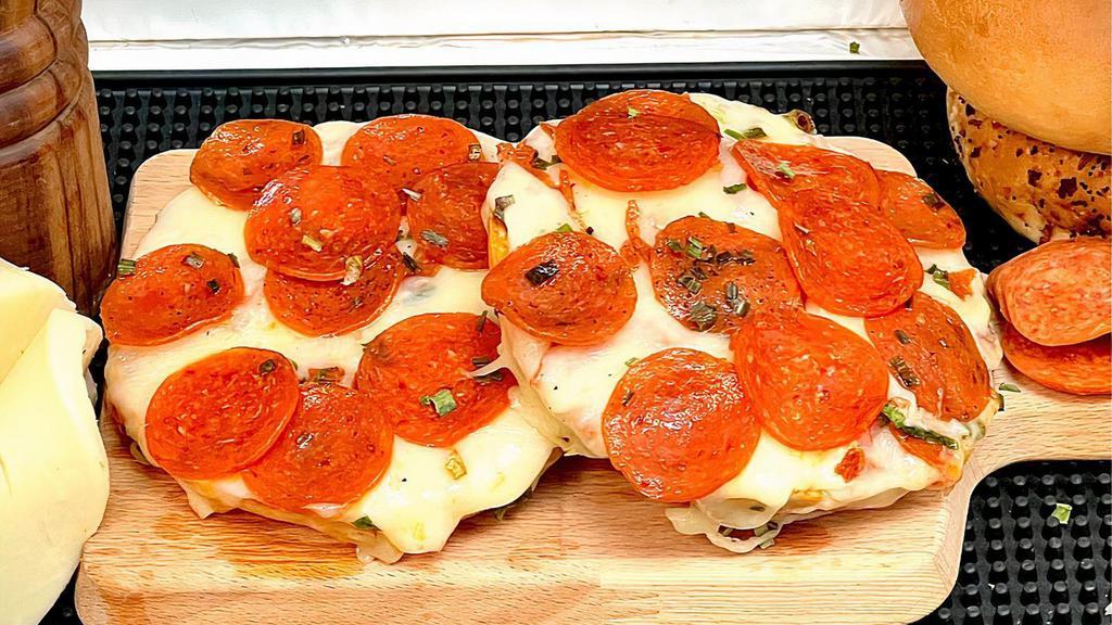 Pizza Bagel · A fresh large bagel sliced and prepared with organic pizza sauce and mozzarella cheese.