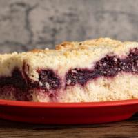 Kirschstreusel (Cherry), Piece · cake with black cherries and topped with streusel.