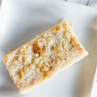 Peach Streusel, Piece · cake with peaches, bavarian custard, and topped with streusel.