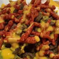 Hot Cheetos Nachos · Sour cream, guacamole, nacho cheese, hot cheetos, and carne asada