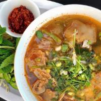Spicy Beef Noodle Soup · Spicy beef noodle soup paired with tender slices of beef and pork feet, then topped with fre...