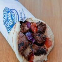 Filet Mignon Steak Kebab Wrap · Grilled filet mignon steak wrapped in pita with tomatoes, onions, and hummus.