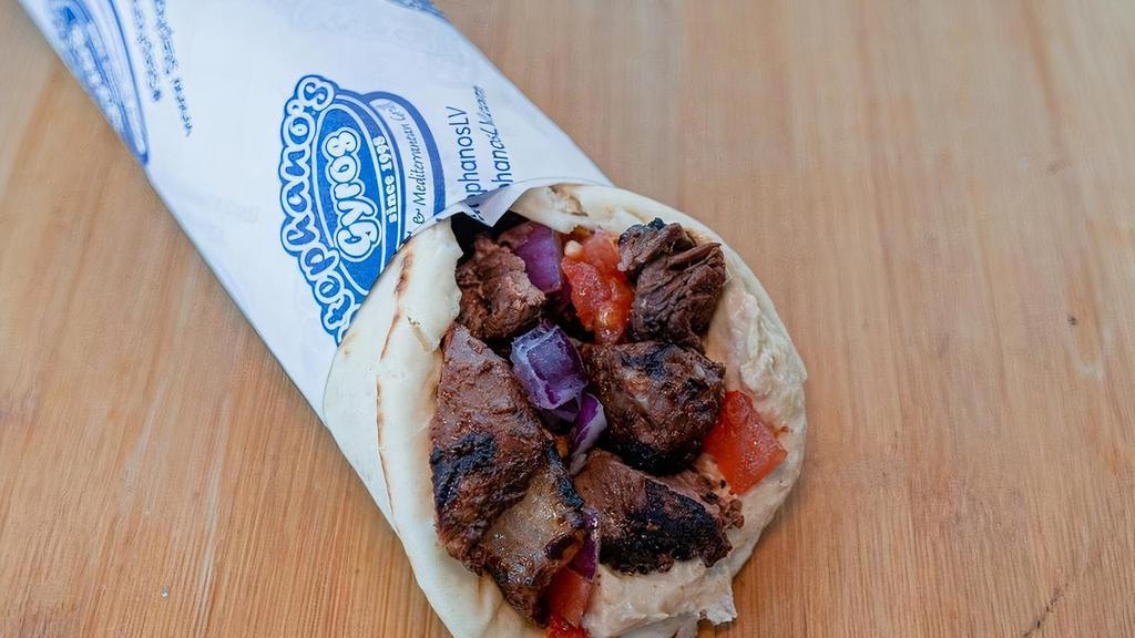 Filet Mignon Steak Kebab Wrap · Grilled filet mignon steak wrapped in pita with tomatoes, onions, and hummus.