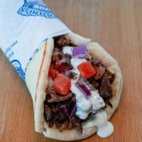 Beef Shawerma Wrap · Beef shawarma slices wrapped in pita bread with tomatoes, onions, garlic sauce and tahini sa...