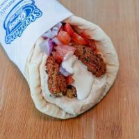 Falafel Wrap · Falafel pieces wrapped in pita bread with tomatoes, onions, hummus, and tahini sauce.