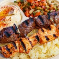 Combo Plate · Choose two kebabs or meats. Served with hummus, Israeli salad, rice, and two pieces of pita ...