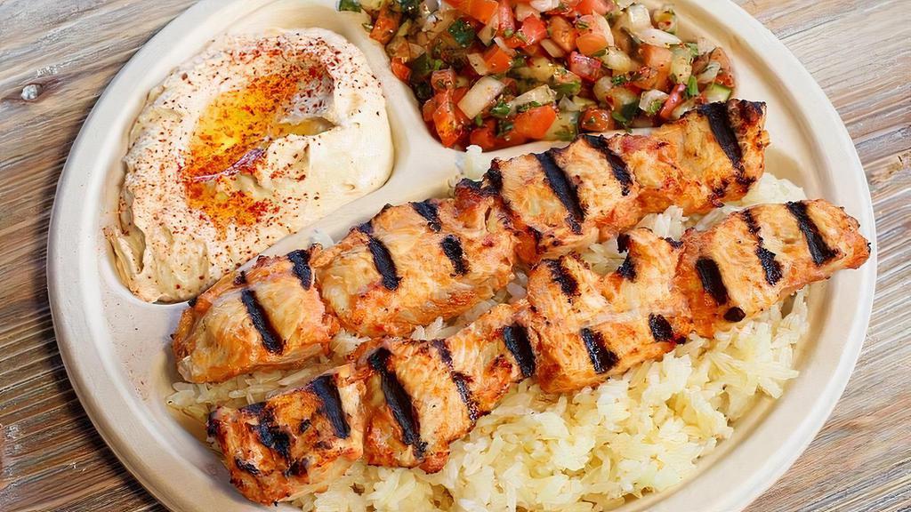 Chicken Kebab Plate · Two marinated skewers of premium cut chicken breast kebab. Served with hummus, Israeli salad, rice, and two pieces of pita bread.