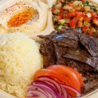 Beef Shawerma Plate · Beef sliced from a vertical spit with tahini sauce or tzatziki sauce. Served with hummus, Is...