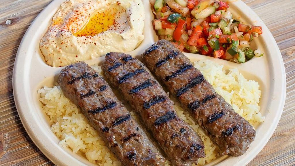 Kofta(Ground Beef) Plate · Two premium ground beef kebabs. Served with hummus, Israeli salad, rice, and two pieces of pita bread.