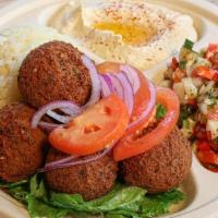 Falafel Plate · Five pieces of falafel, tomatoes, onions, and tahini sauce. Served with hummus, Israeli sala...
