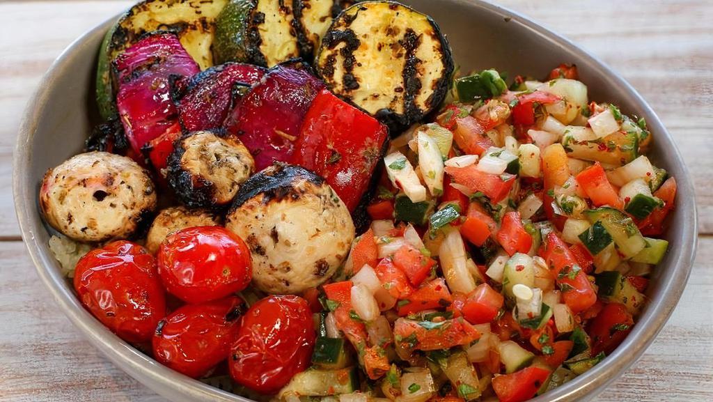 Veggie Kebab Bowl · Marinated skewers of mushroom, tomato, onion, zucchini, and bell peppers with rice, Israeli salad and pita.
