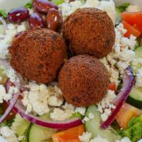 Falafel Salad · Served with lettuce, tomatoes, onions, cucumbers, feta cheese, olives, tahini sauce and two ...