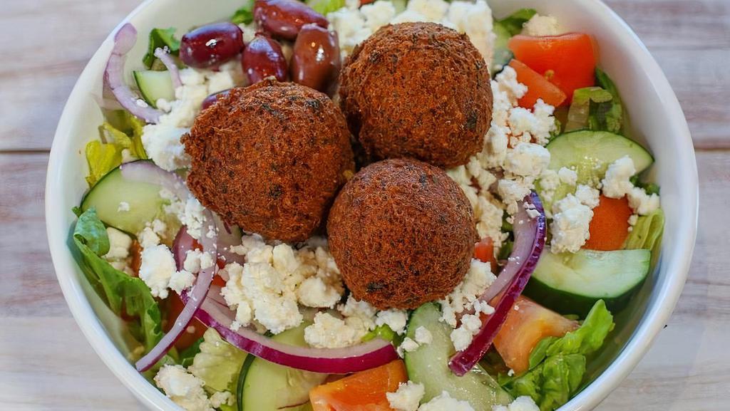 Falafel Salad · Served with lettuce, tomatoes, onions, cucumbers, feta cheese, olives, tahini sauce and two pieces of pita. Topped with 3 falafel balls.