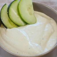 Tzatziki · Tzatziki is a dip made of yogurt and sour cream mixed with cucumbers, garlic, salt, olive oi...