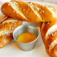 Bavarian Pretzels (3) · Three bavarian-style pretzel sticks, salt, house cheese sauce.