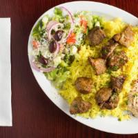 Lamb Shish Kabab Plate · Marinated lamb cubes barbecued and  served with rice, hummus, and garlic and tahini sauce on...