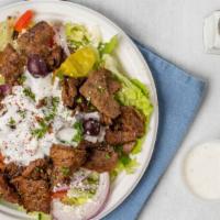 Lamb And Beef Gyro Salad · Romaine lettuce, tomatoes, cucumbers, red  onions, Kalamata olives with dressing, topped wit...