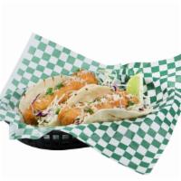Pacific Cod · Two tacos with coleslaw, cilantro, and cotija cheese.