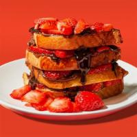 Nutella & Strawberry French Toast · Four slices of egg-washed french toast topped with nutella, strawberries, maple syrup, and b...