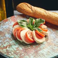 Caprese Salad · Sliced Fresh Mozzarella, Italian Plum Tomatoes and Garden Basil Chiffonade, Drizzled with Ex...