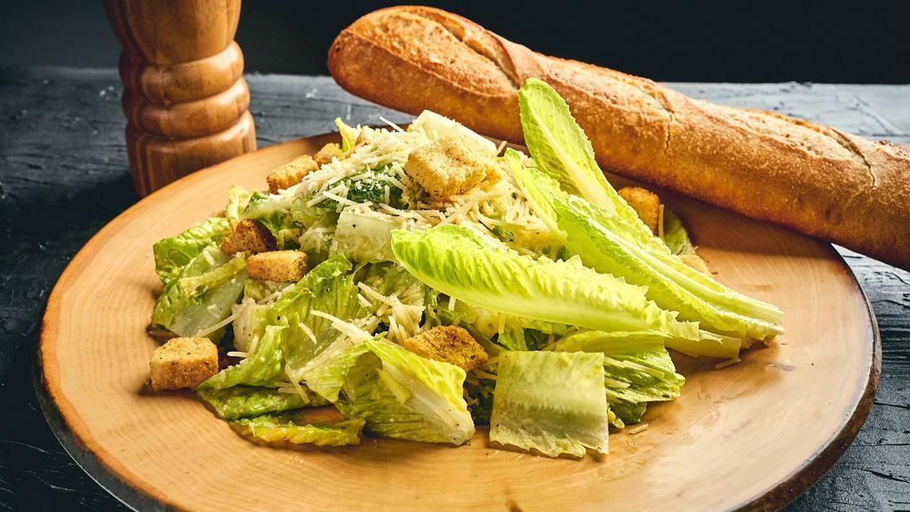 Caesar Salad · Chopped Romaine, Shredded Parmesan Cheese, Roasted Garlic & Herb Croutons, Creamy Caesar Dressing