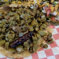 Rajas Taco · Sauteed poblano peppers with corn, garlic & onion in a  creamy sauce. 
Vegetarian friendly.