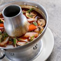 Tom Yum · Hot and sour soup flavored with lemongrass, cilantro, fresh chilies, mushrooms, lime leaf, l...