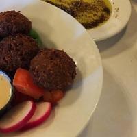 Falafel (Vegetarian) · Garbanzo beans, vegetables, spices, fried and tahini sauce.