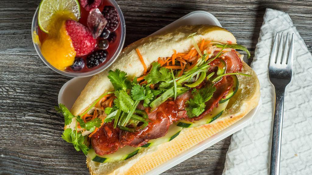 Bánh Mì Sandwich · Toasted French baguette serve with choices of lettuce : pickle carrots and daikon or pickle pepper onion, tomatoes, cucumber, jalapeño, cilantro. Served with chili-lime fish vinaigrette or  garlic soy-sauce.